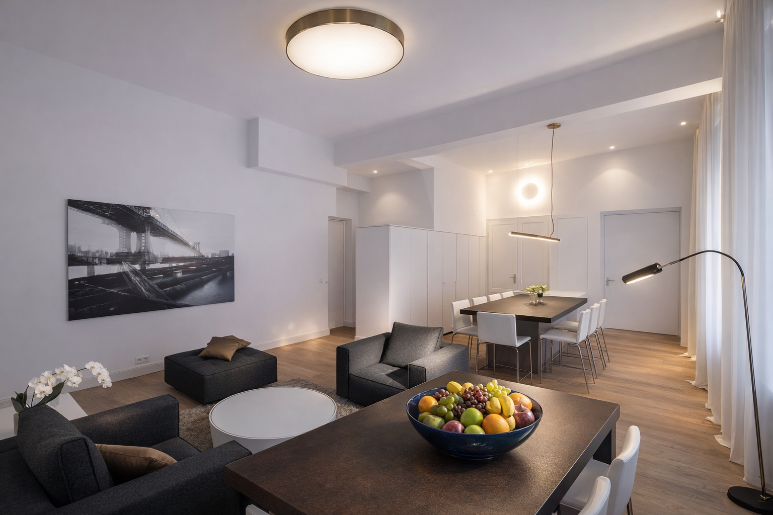 Open kitchen with white island and dark dining table