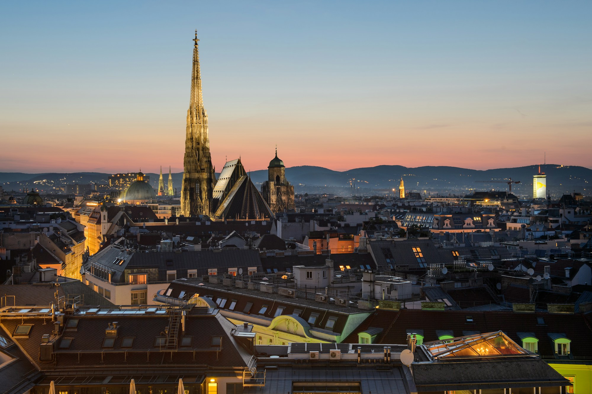 Vienna skyline at dusk with St. Stephen's Cathedral over the rooftops of the first district
